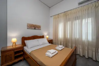 a bedroom with a bed with two towels on it at Plumeria Apartment in Rhodes Town