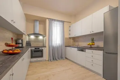 a kitchen with white cabinets and stainless steel appliances at City Choice 2 Live - Sofouli 15 in Rhodes Town