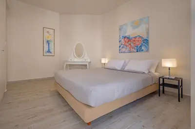 a bedroom with a bed and two lamps and a mirror at City Choice 2 Live - Sofouli 15 in Rhodes Town