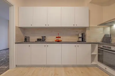 a white kitchen with white cabinets and appliances at City Choice 2 Live - Sofouli 15 in Rhodes Town