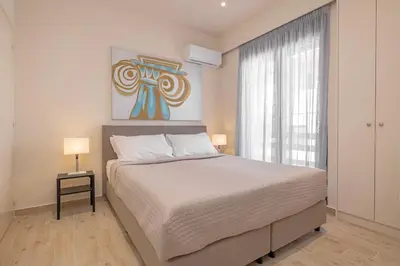 a bedroom with a large bed and a window at City Choice 2 Live - Sofouli 15 in Rhodes Town
