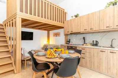 a kitchen and dining room with a table and chairs at Casa Di Kritinia in Kritinía
