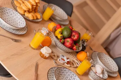 a table topped with a bowl of fruit and juice at Casa Di Kritinia in Kritinía