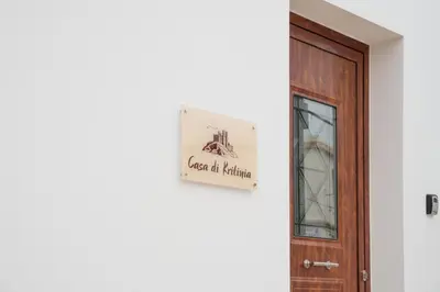 a sign on a wall next to a door at Casa Di Kritinia in Kritinía