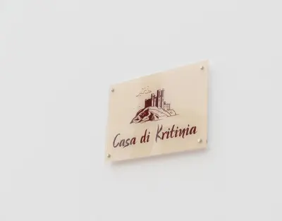 a sign hanging on a wall with a picture of the city at Casa Di Kritinia in Kritinía