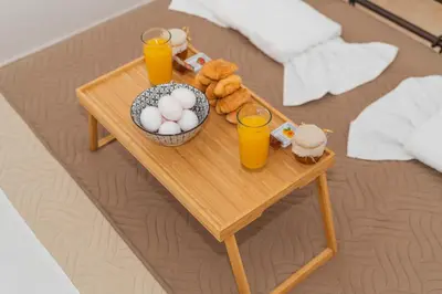 a table with a tray of food and two glasses of orange juice at Casa Di Kritinia in Kritinía