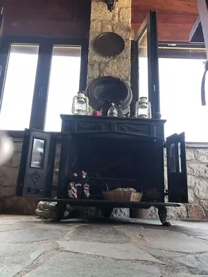 a black fireplace in a room with windows at Liros in Kamiros