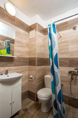 a bathroom with a toilet and a sink at Nikos BnB in Faliraki