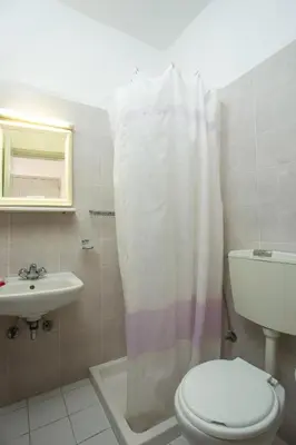 a bathroom with a toilet and a sink at Nikos BnB in Faliraki