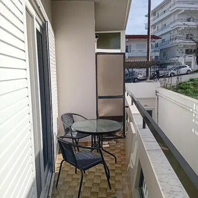 a small balcony with a table and chairs on it at Dioni of Rhodes in Rhodes Town