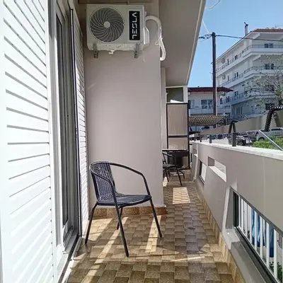 a chair sitting on the balcony of a building at Dioni of Rhodes in Rhodes Town