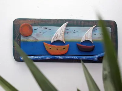 a picture of two boats on a blue shelf at Sunrise Apartments in Livadia