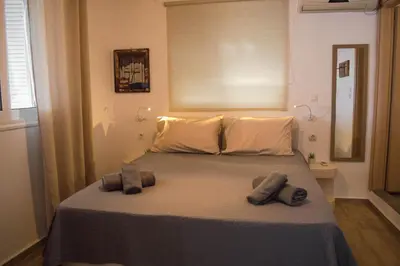 a bedroom with a bed with two towels on it at Sunrise Apartments in Livadia