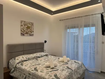 a bedroom with a bed with two white towels on it at CARISSA SUITES a in Afantou