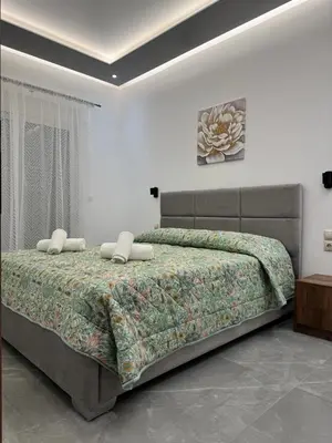 a bedroom with a bed with two pillows on it at CARISSA SUITES a in Afantou