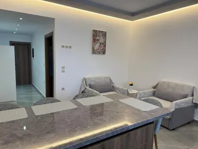 a kitchen with two chairs and a counter top at CARISSA SUITES a in Afantou