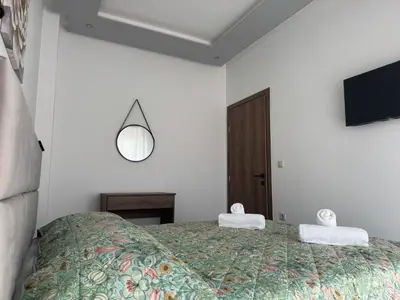 a bedroom with a bed with two towels on it at CARISSA SUITES a in Afantou