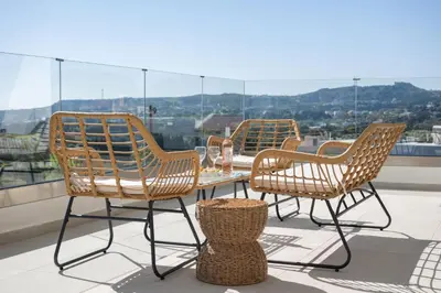 a group of chairs and a table on a roof at Blue Hills Villa in Kallithea Rhodes