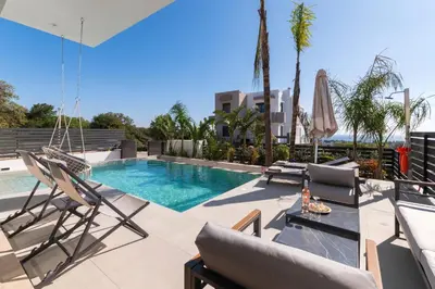 a patio with chairs and a swimming pool at Blue Hills Villa in Kallithea Rhodes