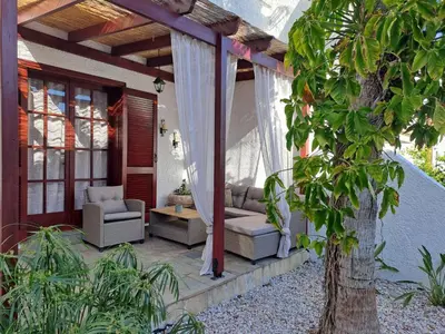 a patio with a couch and chairs on a house at Bella Vita Ixia in Ixia