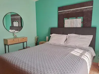a bedroom with a large bed and a mirror at Bella Vita Ixia in Ixia