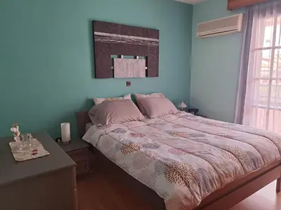 a bedroom with a large bed with pink pillows at Bella Vita Ixia in Ixia