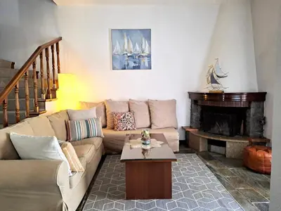 a living room with a couch and a fireplace at Bella Vita Ixia in Ixia