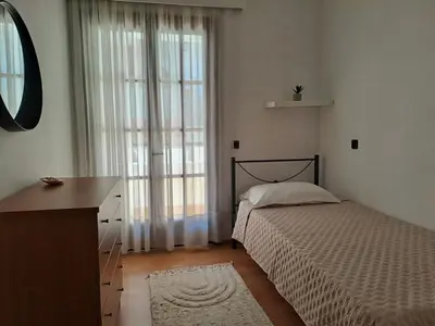 a bedroom with a bed and a dresser and a window at Bella Vita Ixia in Ixia
