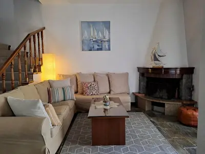 a living room with a couch and a fireplace at Bella Vita Ixia in Ixia