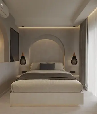 a bedroom with a large bed and two lights at néreya luxury rooms in Haraki