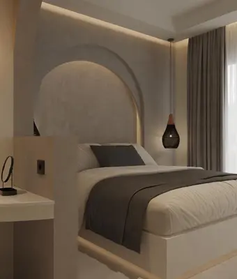 a bedroom with a large bed with an arch above it at néreya luxury rooms in Haraki