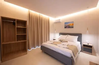 a bedroom with a bed with towels on it at Blue Wave Suites - Ixia in Ialyssos