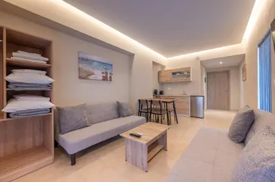 a living room with a couch and a table at Blue Wave Suites - Ixia in Ialyssos