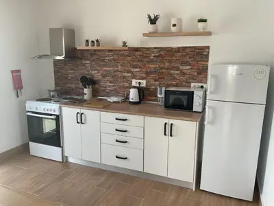 a kitchen with a white refrigerator and a microwave at Telis House in Rhodes Town