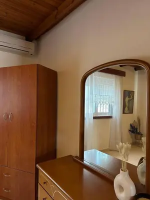 a bathroom with a large mirror and a dresser at Levante Apartment for 4 in Faliraki