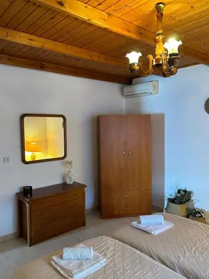 a bedroom with a bed and a mirror and a dresser at Levante Apartment for 4 in Faliraki