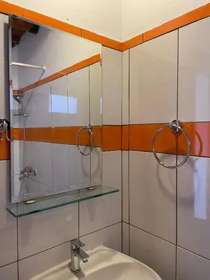a bathroom with a sink and a mirror at Levante Apartment for 4 in Faliraki