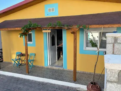 a small house with a porch and a patio at Levante Apartment for 4 in Faliraki
