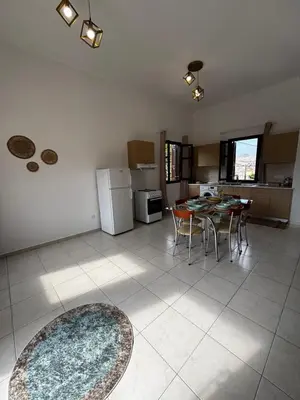 a kitchen with a table and chairs in a room at Amelia's Home in Symi