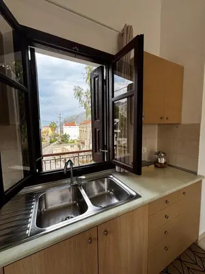 a kitchen with a sink and a window at Amelia's Home in Symi