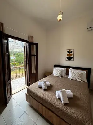 a bedroom with a bed with two towels on it at Amelia's Home in Symi