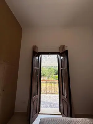 an open door to a bedroom with a view at Amelia's Home in Symi