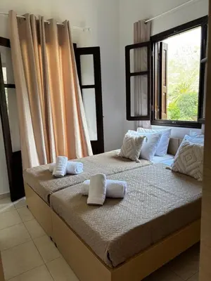 a bedroom with two beds with towels on them at Amelia's Home in Symi