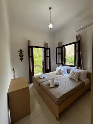 a bedroom with a bed with two towels on it at Amelia's Home in Symi
