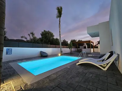 a swimming pool in the backyard of a house at Myrteni Pool Villas in Ialyssos