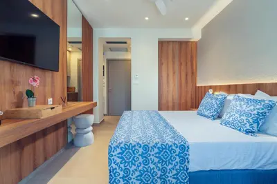 a hotel room with a bed and a television at Cozy Suite in Rhodes Town