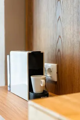 a coffee cup sitting on a counter next to a microwave at Cozy Suite in Rhodes Town
