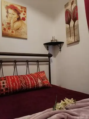 a bedroom with a bed and a painting on the wall at Bersimi Lazaridis in Rhodes Town