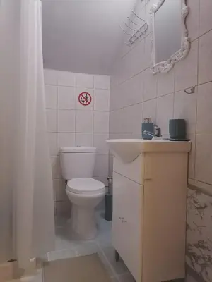 a bathroom with a toilet and a sink and a mirror at Bersimi Lazaridis in Rhodes Town