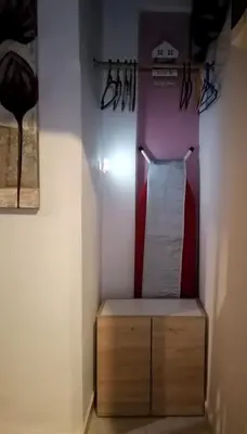 a closet with a wooden cabinet and a towel rack at Bersimi Lazaridis in Rhodes Town